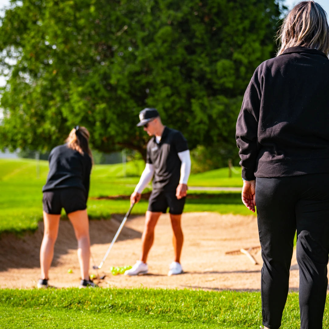 Group of people taking golf lesson in London, Ontario