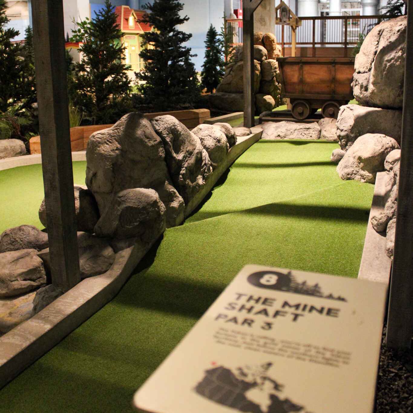 Kids playing golf at indoor mini putt in London, Ontario