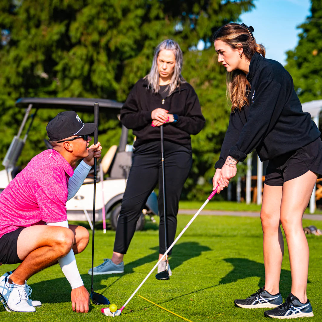 Woman learning golf technique during women's golf class in London Ontario