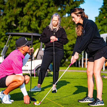 Woman learning golf technique during women's golf class in London Ontario